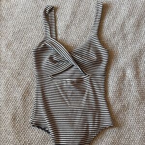 SM Lulus black and white stripped bodysuit with twist front and peek a boo cut